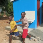 Two sight impaired children walk past the new toilets at the St Francis Madera School for the Blind