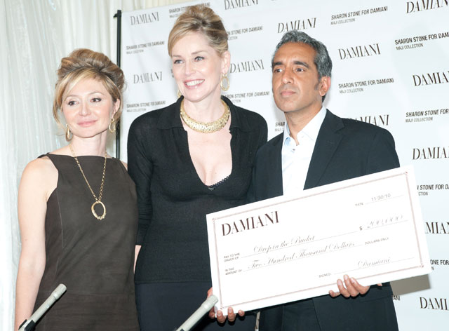 Sharon Stone and Silvia Damiani present John Travis from Drop in the Bucket with a check from the proceeds from the Maji Collection.