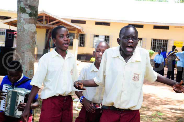 The Soroti RDC, John Stephen Ekomu with a blind pupil cut a tape to commission the boys' water borne toilets at the school. Right is the head teacher, Sister Mary kevin Nasirumbi. - Photo by Eddie Ssejjoba 