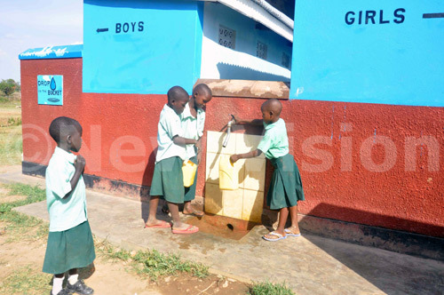 New Vision Uganda - Drop in the Bucket - pupils of Hope Junior School washing their hands after visiting bio-digestion toilets.