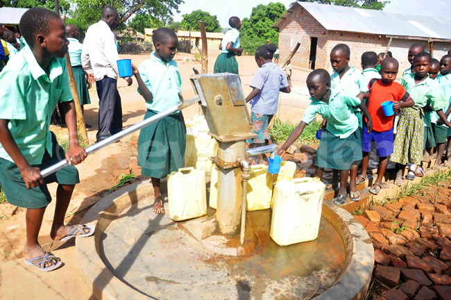 New-Vision-Uganda-Drop-in-the-Bucket - Pupils of Hope Junior School fetching water connected to flush toilets in Soroti district using new technology.