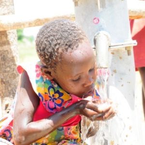 Girl drinking water at the Agola Primary School in South Sudan