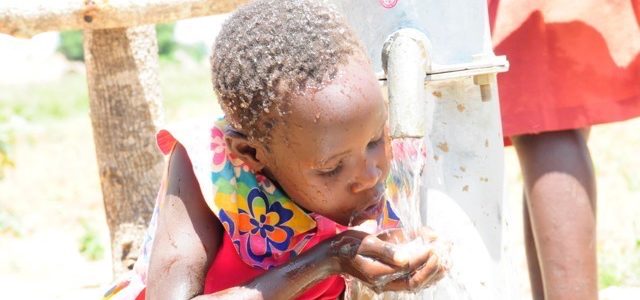 Girl drinking water at the Agola Primary School in South Sudan