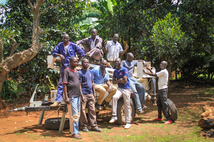 Drop in the Bucket staff sit on a Pat 301T drilling rig in Uganda after completing drilling a new water well in Koboko celebrating World Water Week