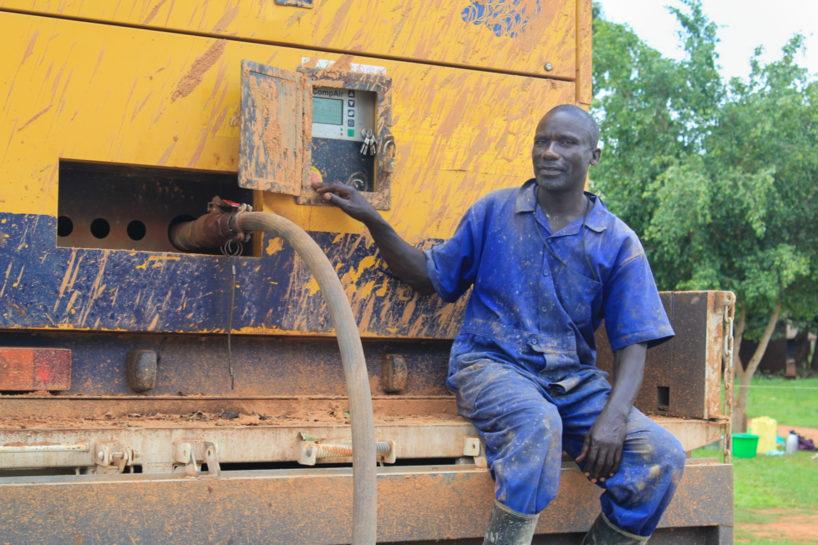 Drop in the Bucket driller sits on a Compair screw tack compressor in Uganda highlighting importance of World Water Week