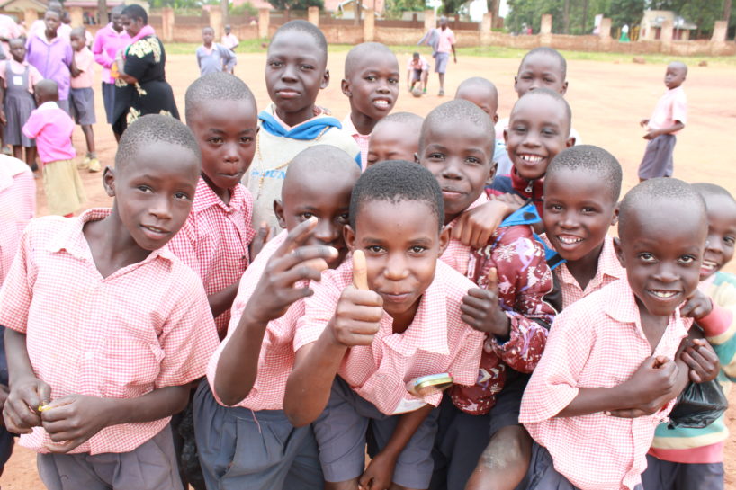 Happy students by a water well drilled by Drop in the Bucket at a school in Uganda