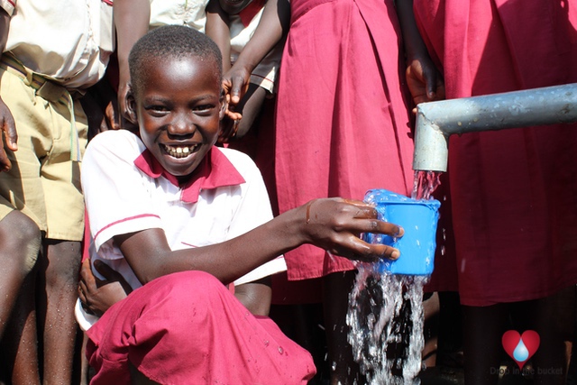 Girl drinking clean water from a new well drilled by Drop in the Bucket at the Busia Primary School in Koboko, Uganda.