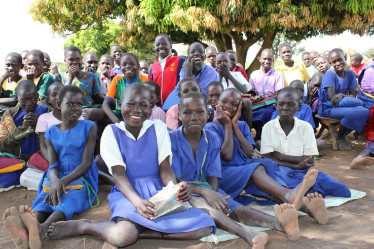 A large group of students in Uganda smile for Drop in the Bucket