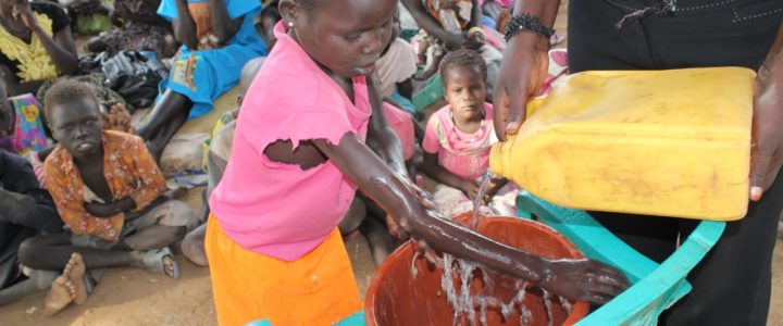 Drop in the Bucket hygiene and sanitation trainers teaching effective hand washing to South Sudanese refugee children.