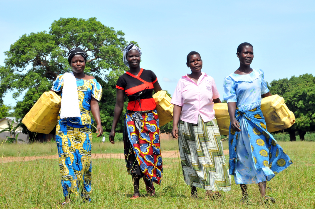 Four African women stand together, representing the power of transforming communities with clean water and education.