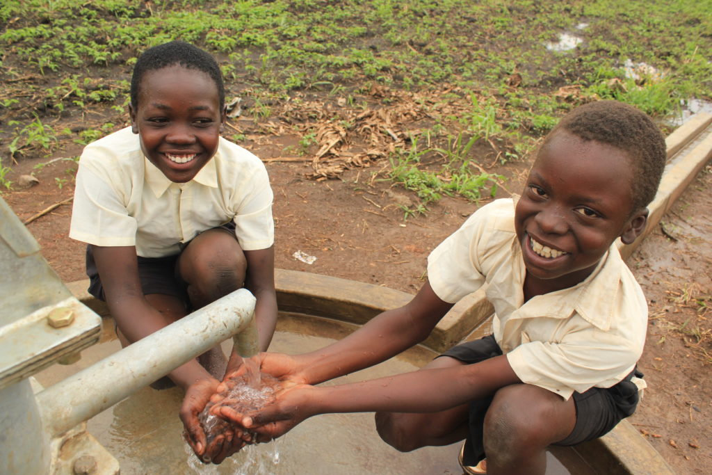 Students accessing clean water from the new well