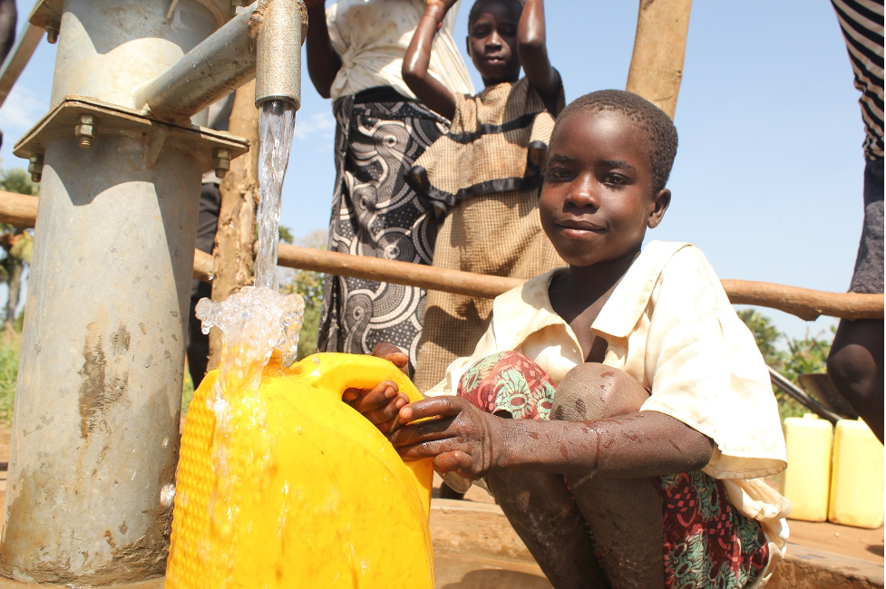 Children enjoying clean water at the new well drilled by Drop in the Bucket