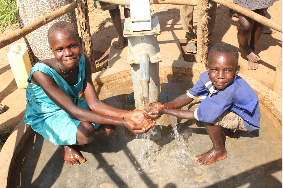 Children at Kati Kati West in Uganda enjoying clean water from the new well drilled by Drop in the Bucket