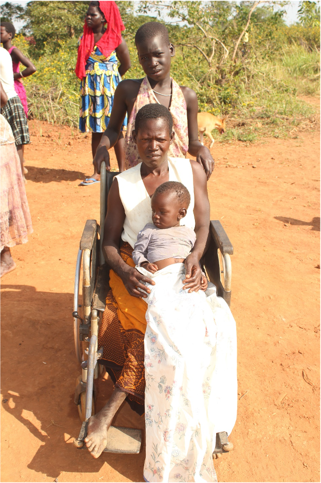 Ajok Nighty with her daughter and her niece by the recently drilled Drop in the Bucket well in Gwenotwom Uganda