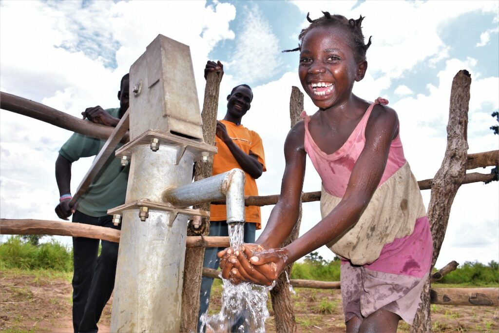 Ajuku Village in Gulu Uganda, gets a new borehole well drilled by Africa water charity Drop in the Bucket.
