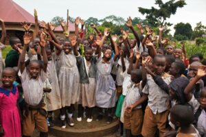 Students stand by the new well drilled by Drop in the Bucket at Bulubandi primary school in Uganda