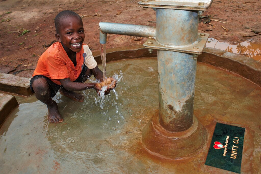 A child washes his hands at the new well drilled by Drop in the Bucket for the St. Vicent Buliganwa primary school in Uganda