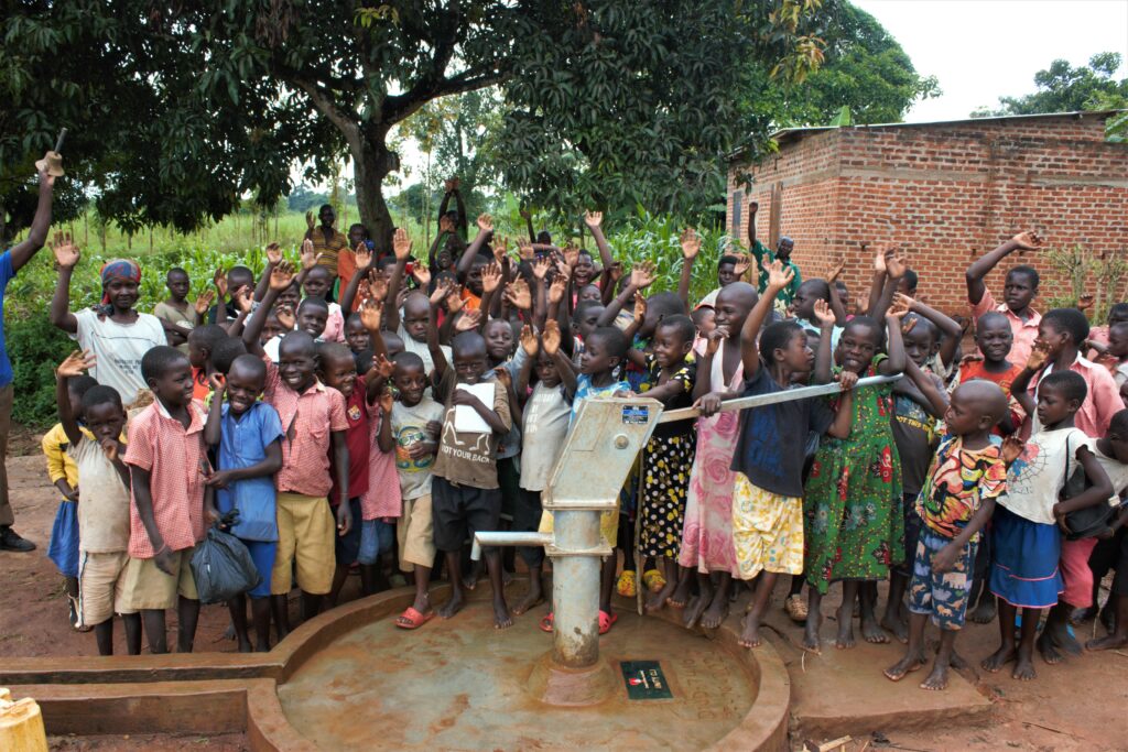 Students and the local community celebrate the new well at the The new well at St Vicent Buliganwa primary school in Uganda. 