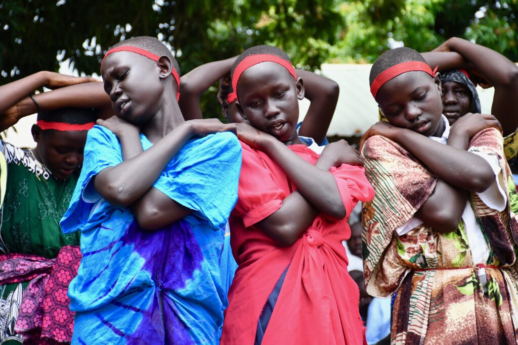 Students performing in a play about hunger at the International Day of the Girl event in Nimule South Sudan sponsored by Drop in the Bucket