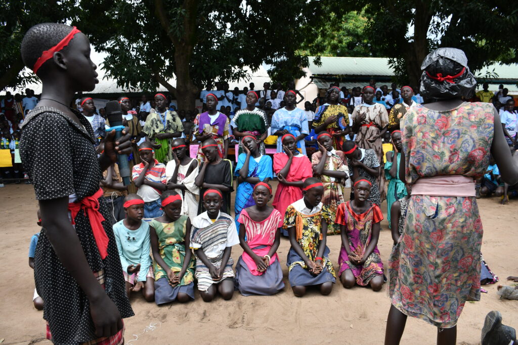 Students performing in a play about hunger at the International Day of the Girl event in Nimule South Sudan sponsored by Drop in the Bucket