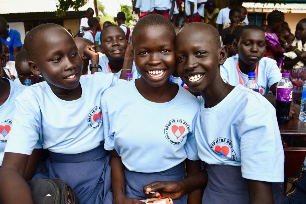 Girls wearing Drop in the Bucket t-shirts an the 2023 International Day of the Girl event in Nimule South Sudan