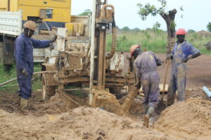 Drop in the Bucket drillers working on a borehole well at Ogom Telela Primary School in Uganda