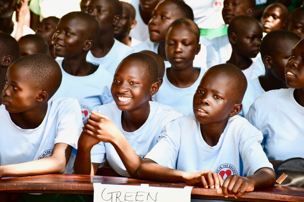 Students listening to speakers in Nimule, South Sudan for International Day of the Girl 2024