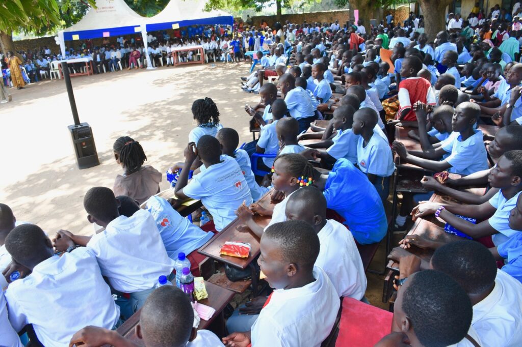 Students listening to speakers in Nimule, South Sudan for International Day of the Girl 2024