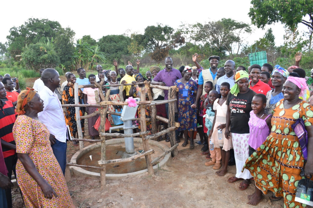 Villagers from Kweyo in Gulu, Uganda, celebrate access to clean water at the well drilled by Drop in the Bucket.