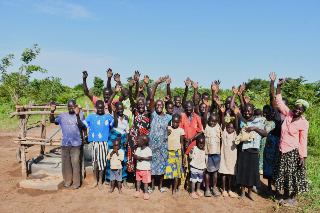 Villagers from Loyoboo wave goodby to the drillers from Drop in the Bucket who recently drilled a water well for this community in Nwoya, Uganda