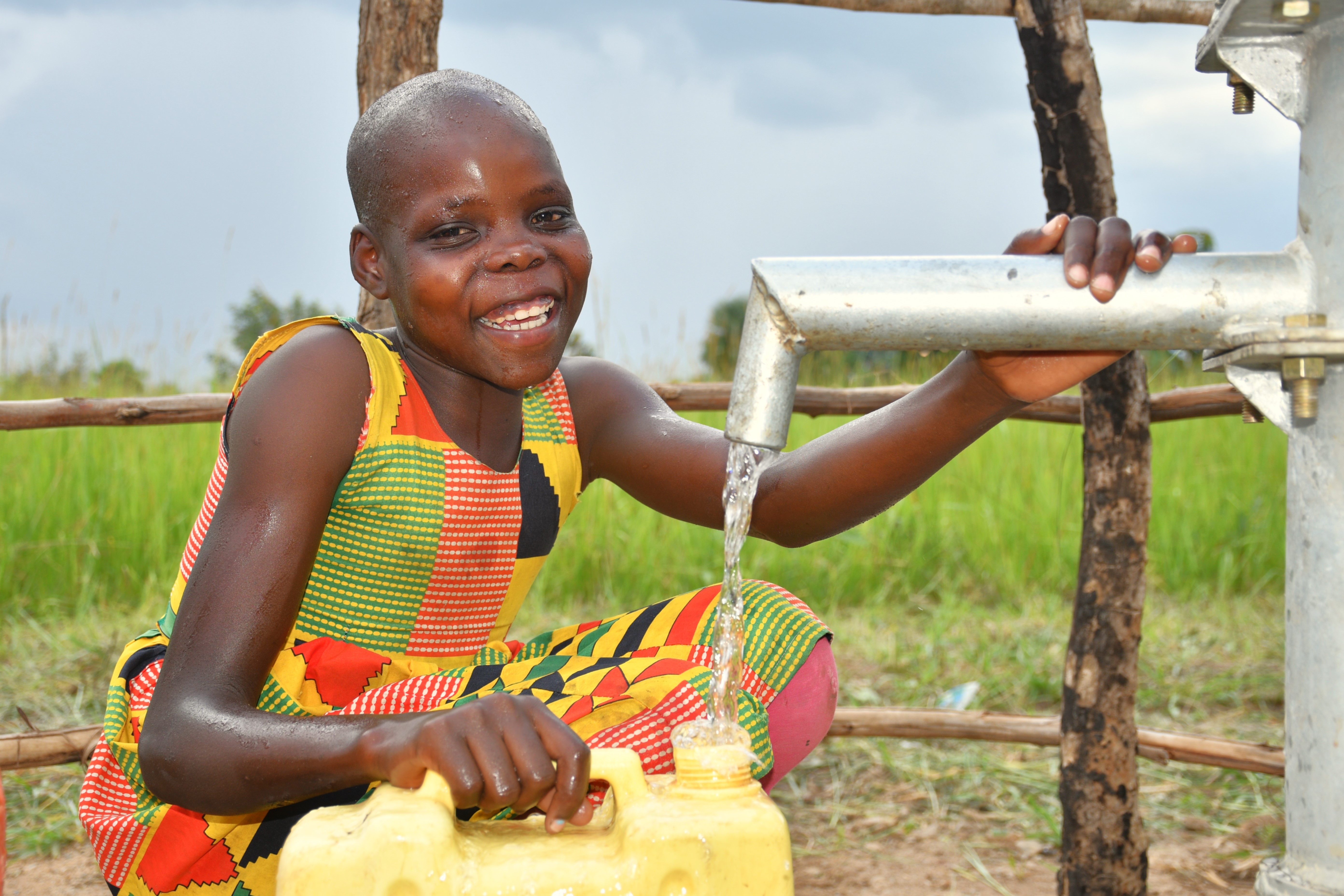 A girl getting clean water from a well drilled by Drop in the Bucket in Labworomor in Nwoya, Uganda