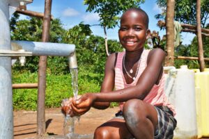 A girl getting clean water from a well drilled by Drop in the Bucket in Laliya Dwol in the Gulu District of northern Uganda