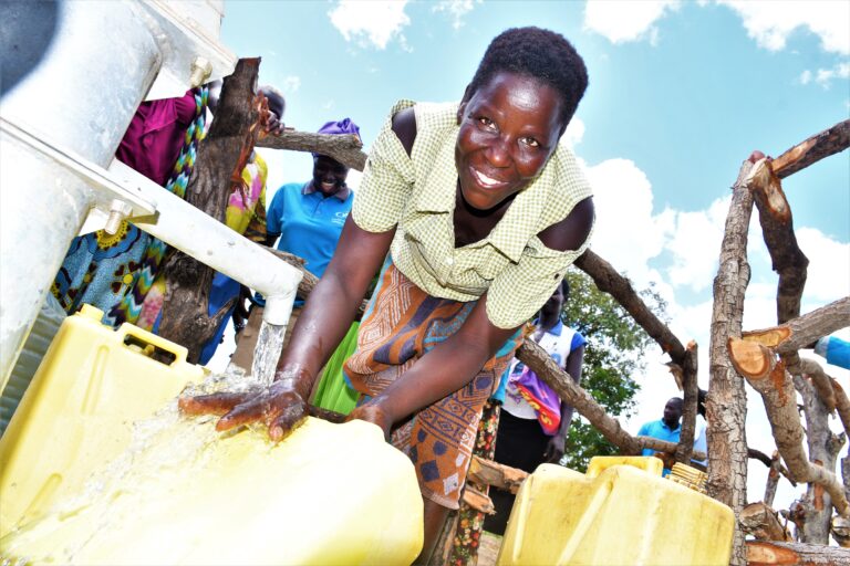 Gulu, Uganda - Layik A - Drop In the Bucket Getting clean water from the new well at Layik A village in Gulu, Uganda where Drop in the Bucket recently drilled a borehole and set up a VLSA.