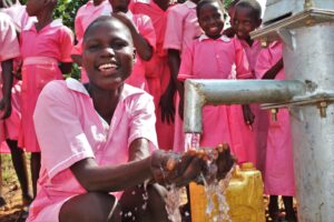 female student from the Kabuli primary school in Iganga Uganda getting clean water from the newly drilled borehole