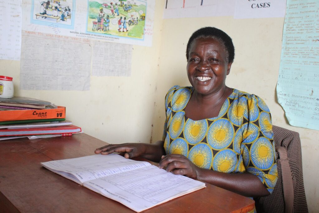 Naluko primary school -Uganda water well - Drop In the Bucket Namaganda Mary headteacher from the Naluko primary school in Uganda at her office desk