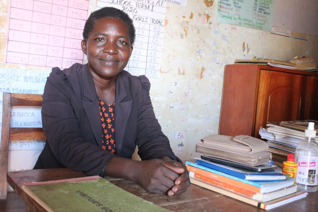 Edith Bajanga, the head teacher of the Nawangisa primary school meets with Drop in the Bucket staff about drilling a well at her school