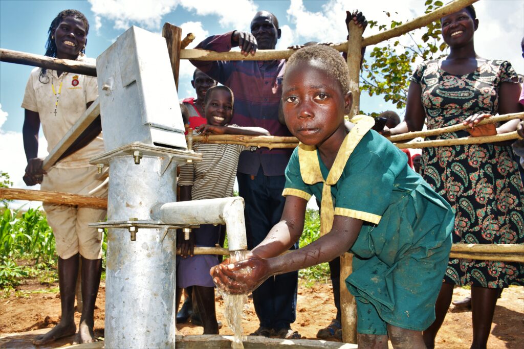 A girl gets clean water from the well at Lamin lawino Ogwari village in Omoro, Uganda.