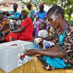 VSLA Members with the lockbox where funds are kept in Layik A village in Iganga, Uganda