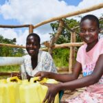 Two girls from the Dudtdut village in the Koro sub-county of the Omoro district in Uganda gets clean water from a newly drilled borehole.