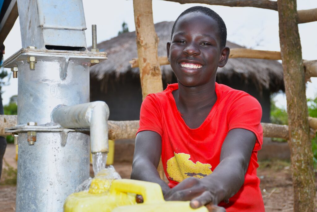 A child from the Dudtdut village in the Koro sub-county of the Omoro district in Uganda gets clean water from a newly drilled borehole.