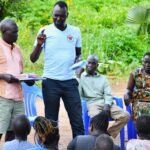 Trainer from Drop in the Bucket at a VSLA meeting in Dudtdut village in the Koro sub-county of the Omoro district in Uganda