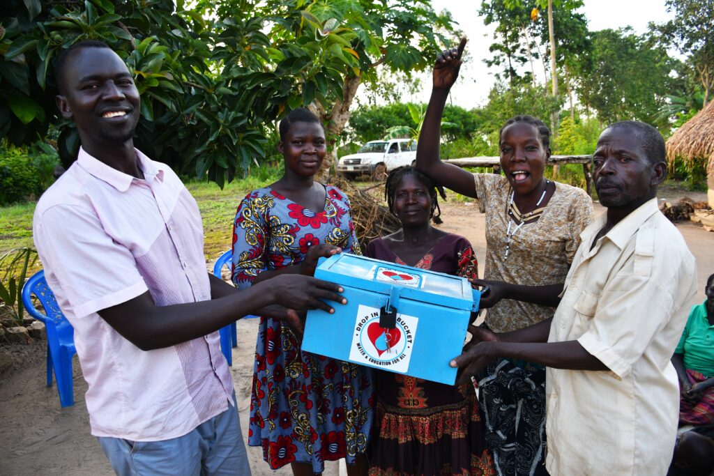 Drop in the Bucket staff member meets with the Bidin B VSLA group in Nwoya, Uganda.