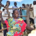 Woman using the new well in Layik A village in Iganga, Uganda