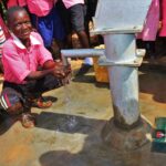 Student from the Kabuli primary school in Iganga Uganda getting clean water from the newly drilled borehole