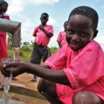 Student from the Kabuli primary school in Iganga Uganda getting clean water from the newly drilled borehole