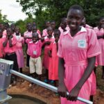 Student from the Kabuli primary school in Iganga Uganda getting clean water from the newly drilled borehole