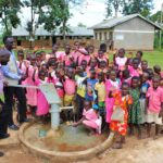 Pupils from the St Joseph's primary school in Inanga, Uganda celebrating the new well drilled by Drop in the Bucket