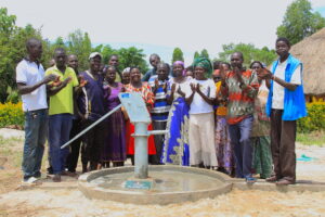 The local community in Latengelere village in Nwoya, Uganda gathers around the newly drilled borehole