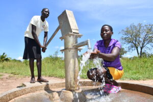 Two girls getting clean water from the well at the Paibona SEED Secondary School near Gulu, Uganda