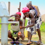 Community stakeholders from Lamoki village in Nwoya, Uganda get water from the borehole drilled by US water charity Drop in the Bucket